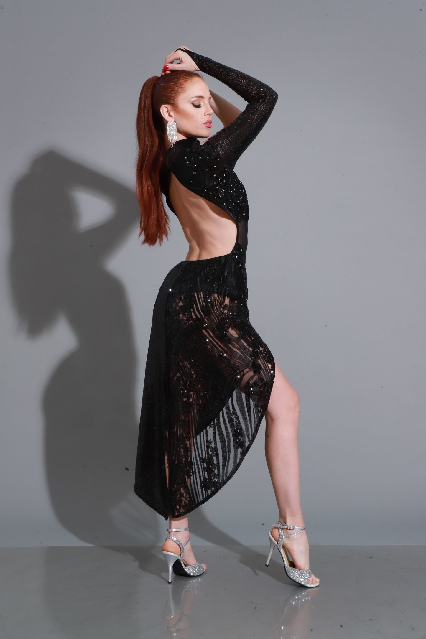 Black sequins with sheer accents and asymmetric neckline — bold, sensual, and striking.