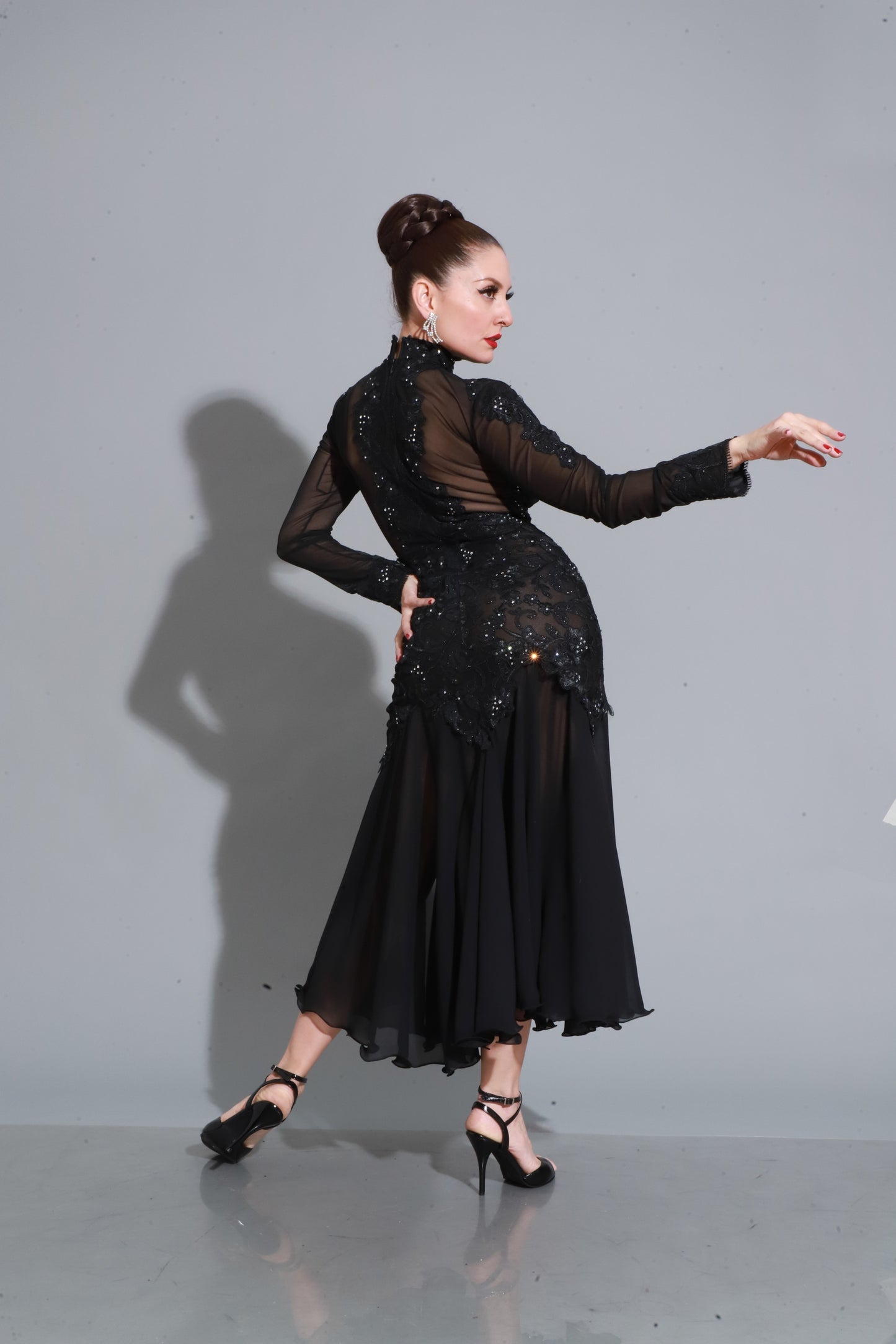 Black lace and satin with sheer details and side slit — sophisticated and sensual for a striking dance look.
