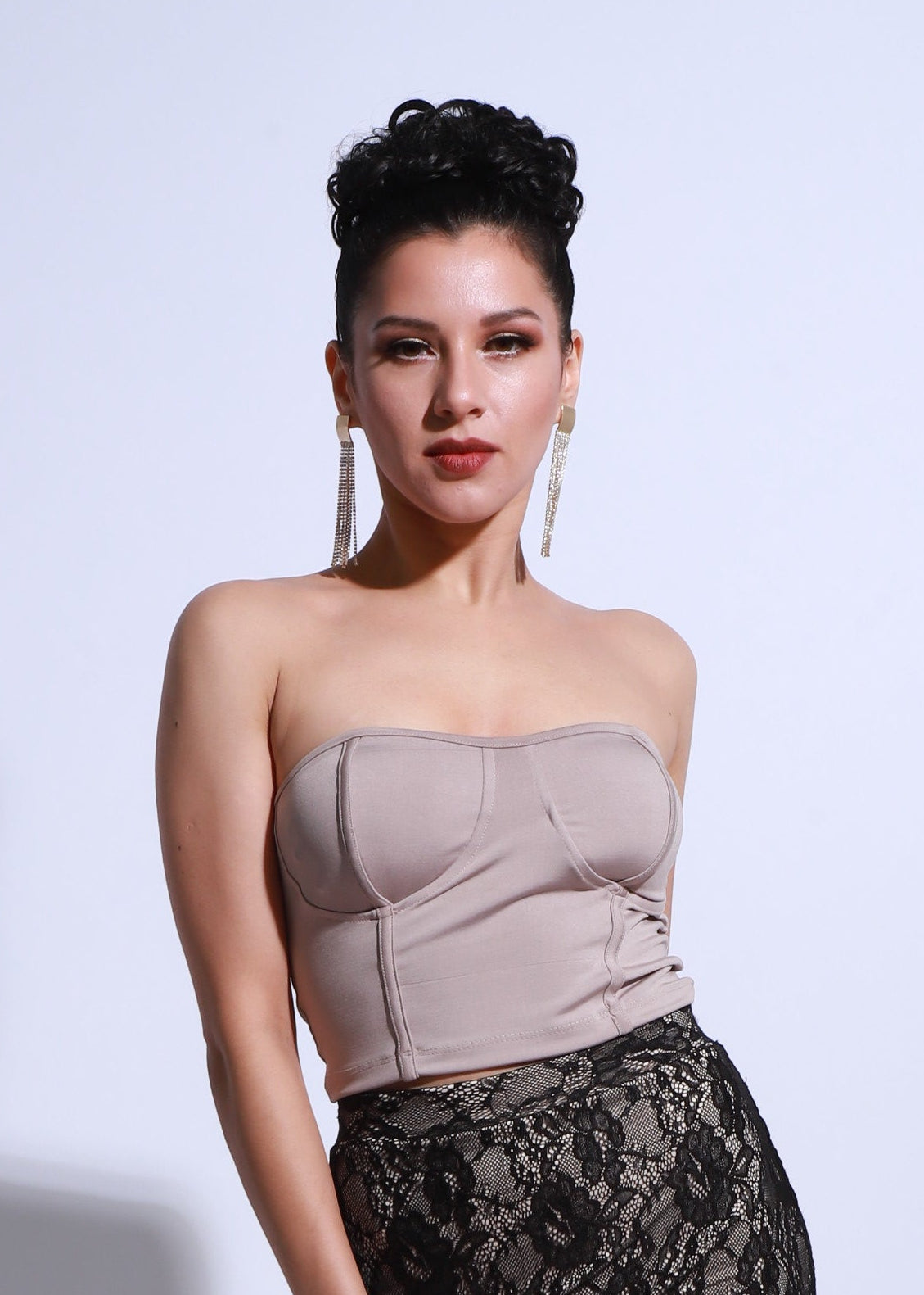 Nude tango top with a fitted silhouette and structured neckline, model shown in a side pose