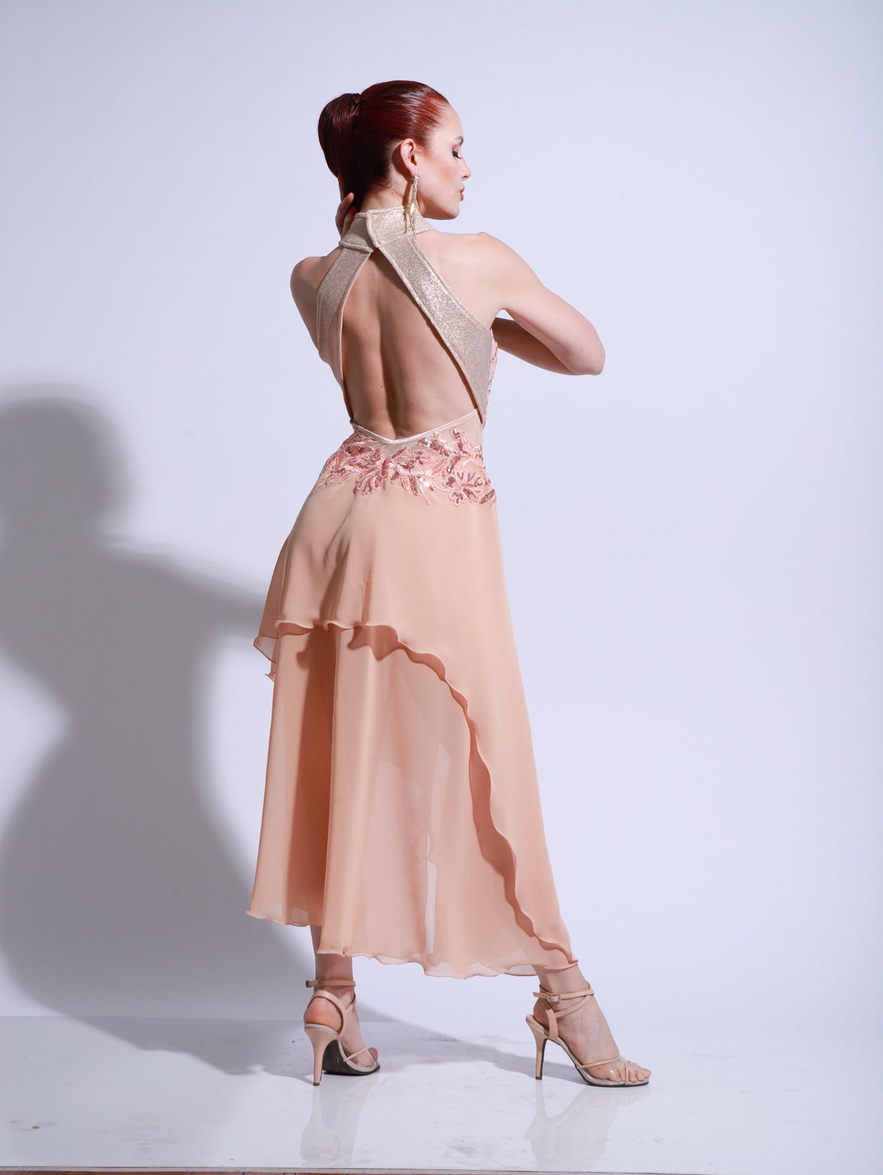 Peach tango salon dress with embroidered lace bodice, halter neckline, and flowing skirt with soft floral appliqués.