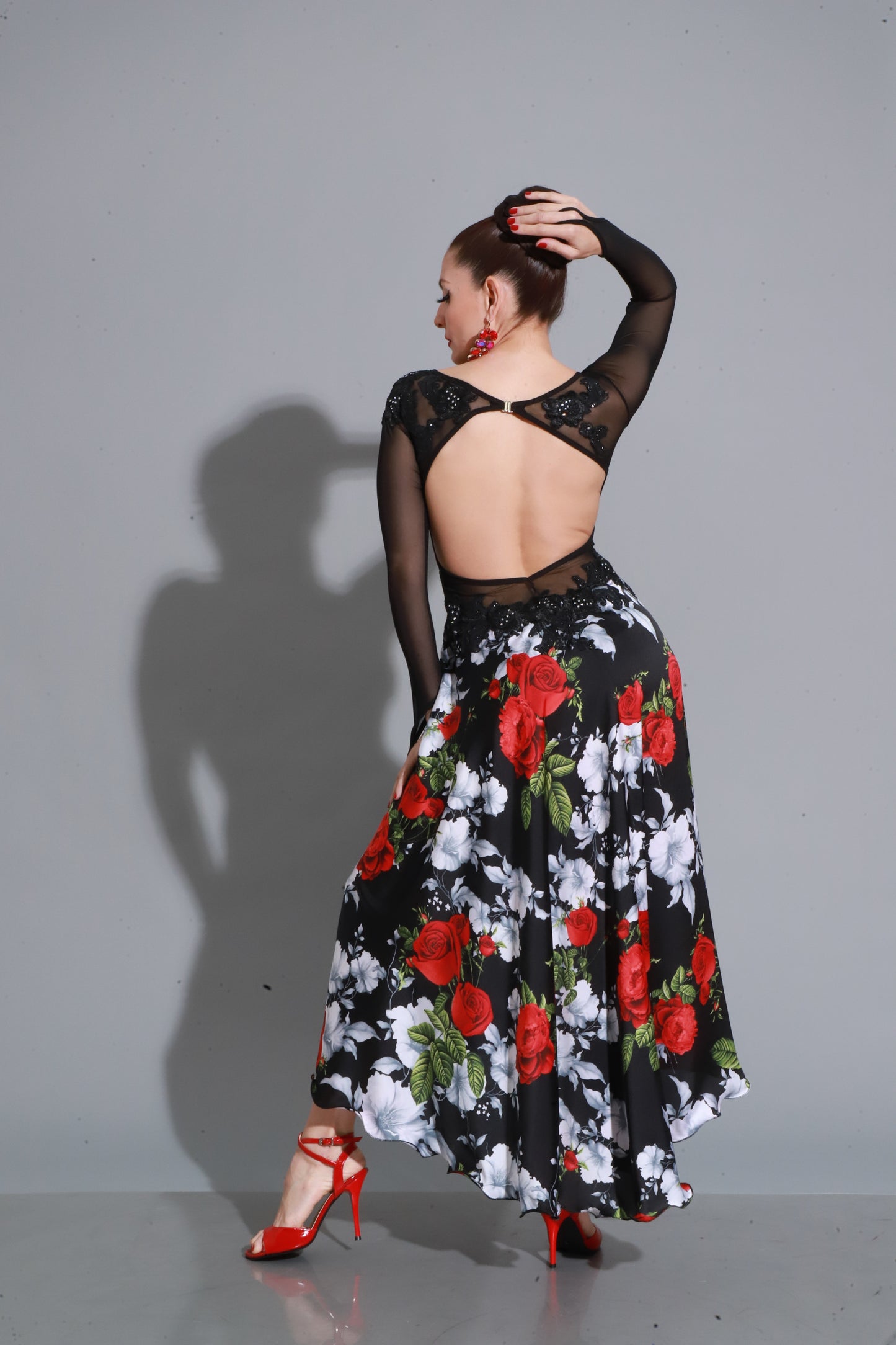 Embroidered black corset with sheer details and a rose-printed skirt — passion, elegance, and striking stage presence.