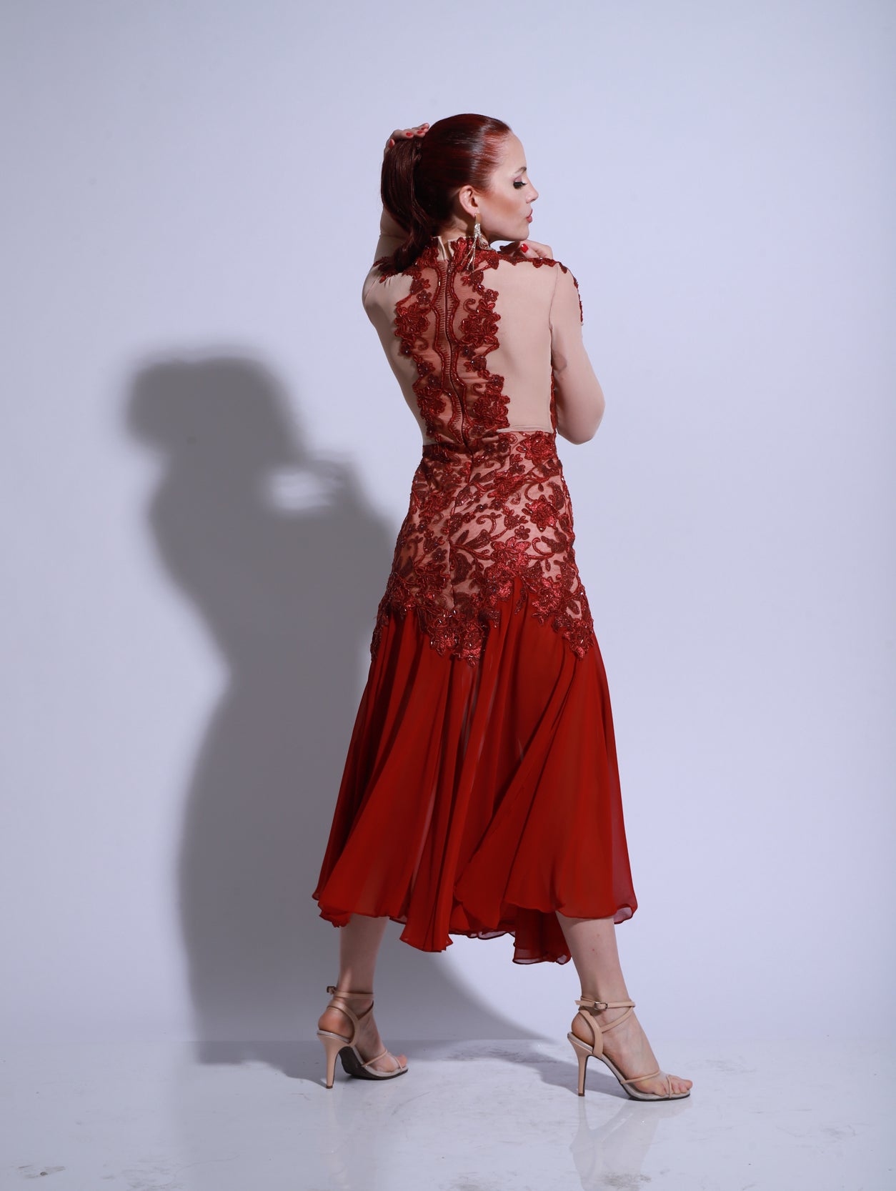 Dress made on a bodysuit base with red paillette and nude tulle for a sheer effect.
Features handcrafted floral embroidery adding texture and shine.
Side-slit skirt enhances movement on stage.