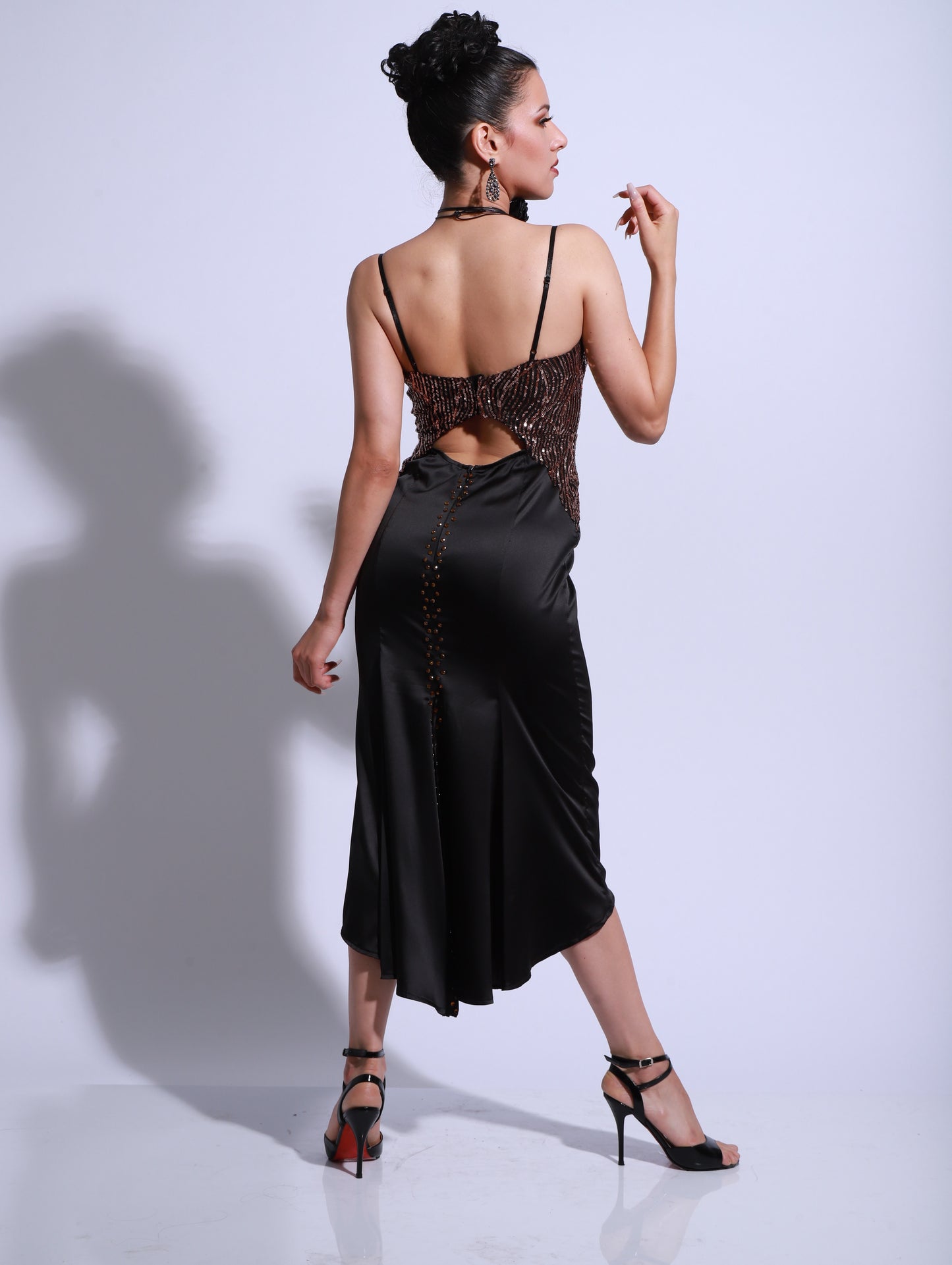 Black satin tango dress with a gold embellished bodice and fitted midi-length skirt.