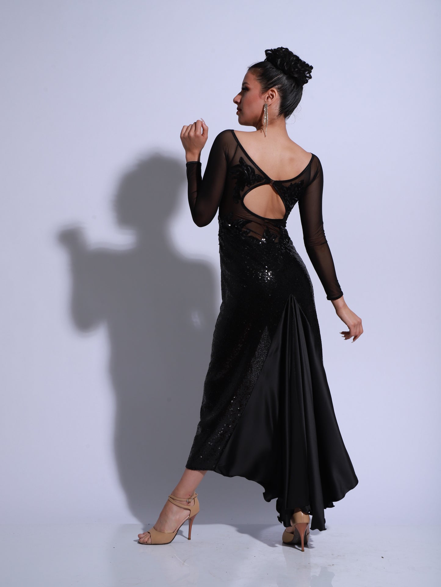 Dress made on a bodysuit base with black paillette and sheer black tulle.
Features handcrafted embroidery that creates a lace-like effect on the skin.
Side-slit skirt enhances movement on stage.