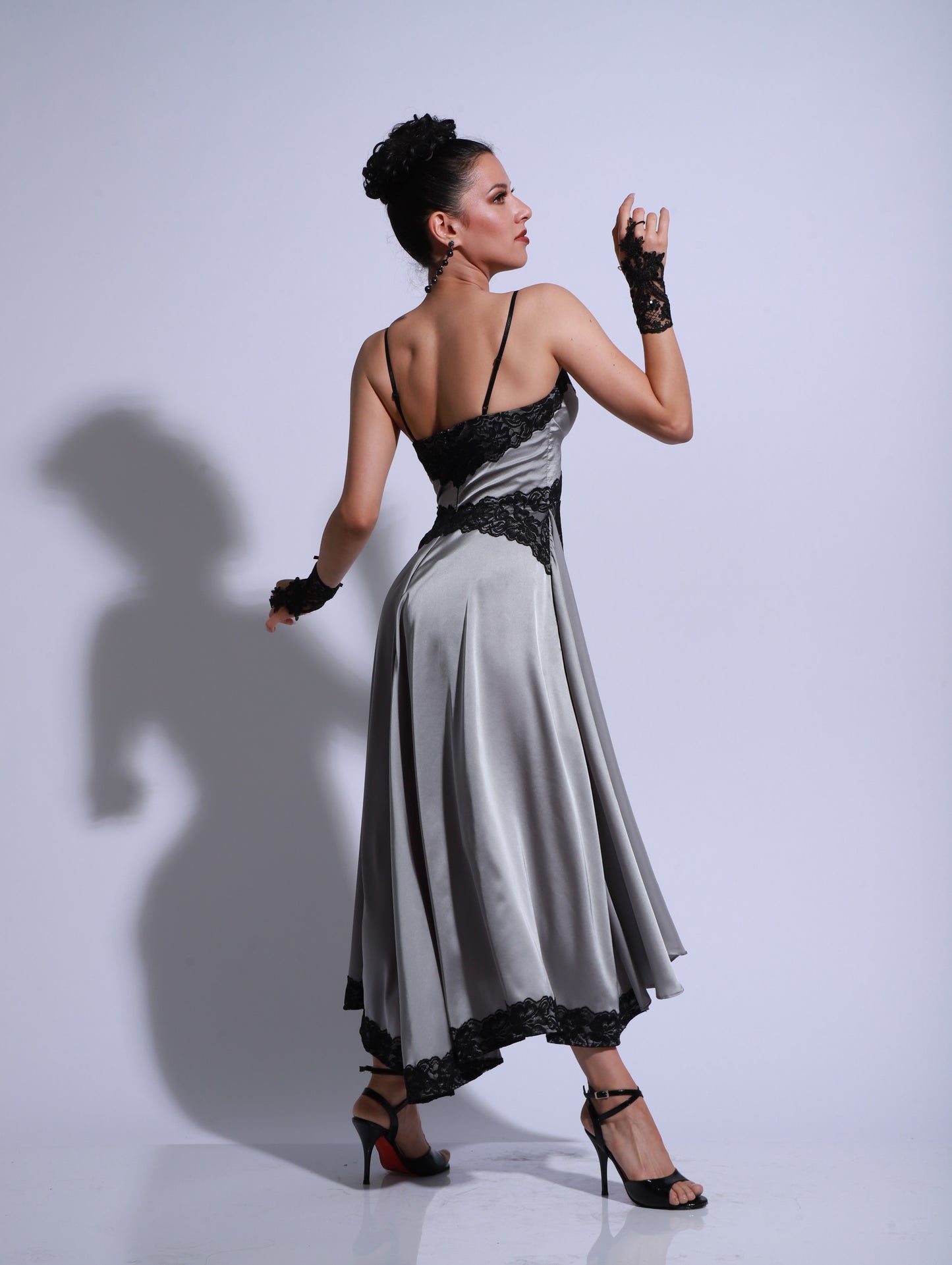 Gray tango dress with an asymmetrical skirt, black lace detailing and a high side slit.