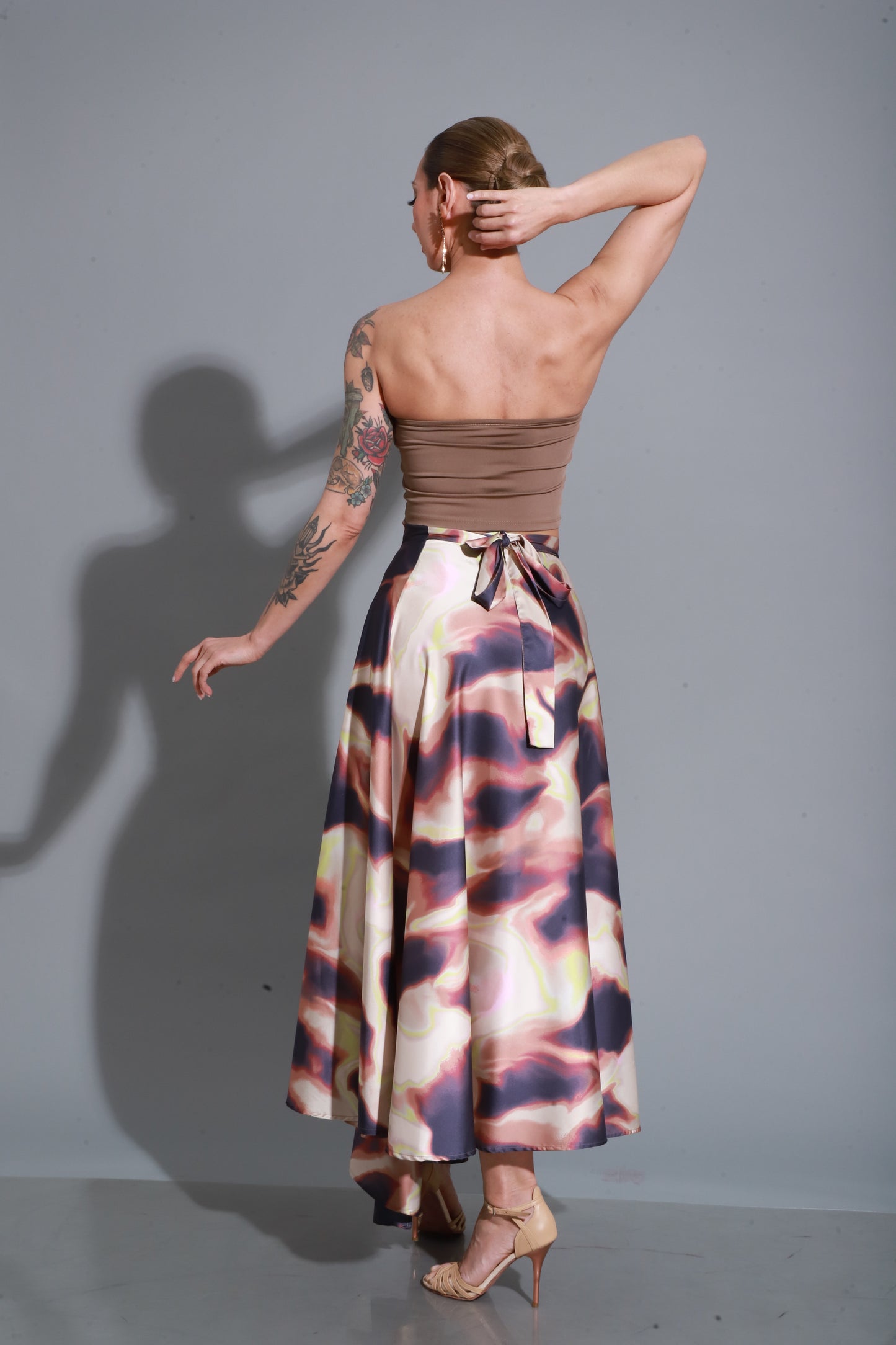 Flowing satin skirt with artistic print, designed to enhance every movement with grace and freedom.
